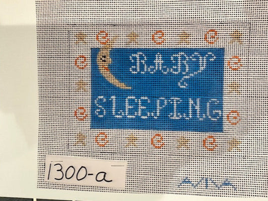  A needlecraft kit depicting a sleeping moon with stars surrounding it. Predominantly blue and white.